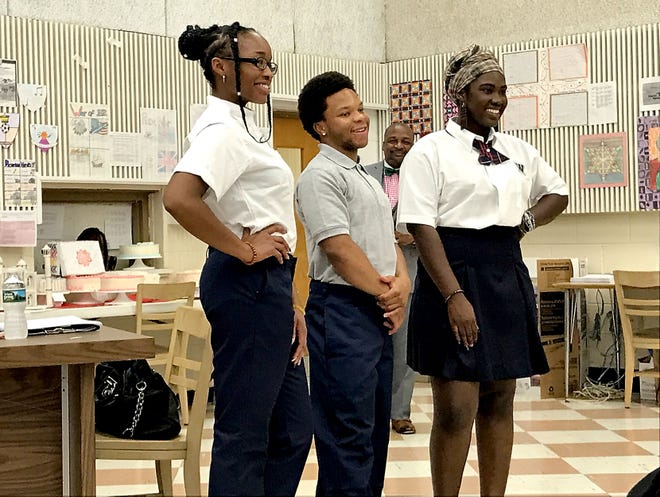 (file) Willingboro High School seniors Chinwendu Chukwu (left), Jamar Sims (center) and Agnesliza Armstrong pose for a picture at the Board of Education meeting on Monday, June 12, 2017, wearing the proposed new uniforms for the high school next year.