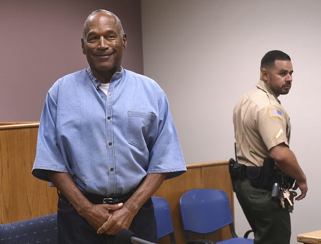 Former NFL football star O.J. Simpson enters for his parole hearing at the Lovelock Correctional Center in Lovelock, Nev., on Thursday, July 20, 2017. Simpson was convicted in 2008 of enlisting some men he barely knew, including two who had guns, to retrieve from two sports collectibles sellers some items that Simpson said were stolen from him a decade earlier. (Jason Bean/The Reno Gazette-Journal via AP, Pool)
