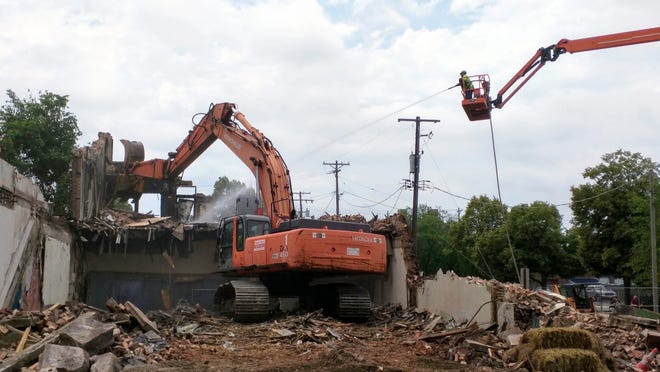 Crews use an excavator to bring down the last remains of a building at 301 Seventh St. on Thursday, July 20, 2017. The vacant second and third floors of the three-story building were heavily damaged by a fire that broke out near the rear of the structure about 11:30 p.m. Sunday, July 2, 2017. [ARTURO FERNANDEZ/RRSTAR.COM]