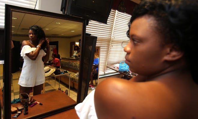 Zari Jones prepares to participate in the Camp Coach Rhodes Fashion Show held at the Neal Senior Center on Saturday. [Brittany Randolph/The Star]