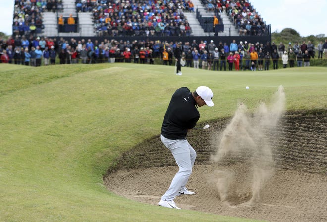 Brooks Koepka of the United States plays out of a bunker on the 7th hole during the first round of the British Open Golf Championship, at Royal Birkdale, Southport, England, Thursday. [THE ASSOCIATED PRESS / PETER MORRISON]