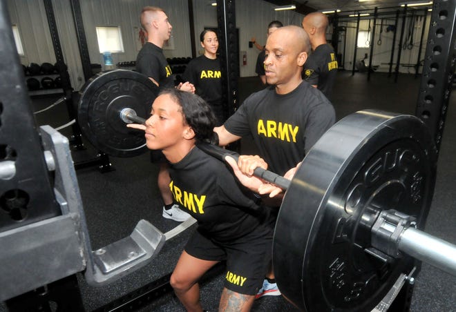 Sgt. Megan Garrett does a squat as Sgt. Edwin Smith spots her during the Master Fitness Trainer Course at Joint Base McGuire-Dix-Lakehurst on Thursday, July 20, 2017.
