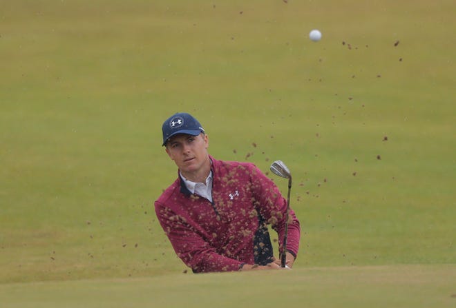 Jordan Spieth hits his ball out of a bunker on the 14th hole on Friday.