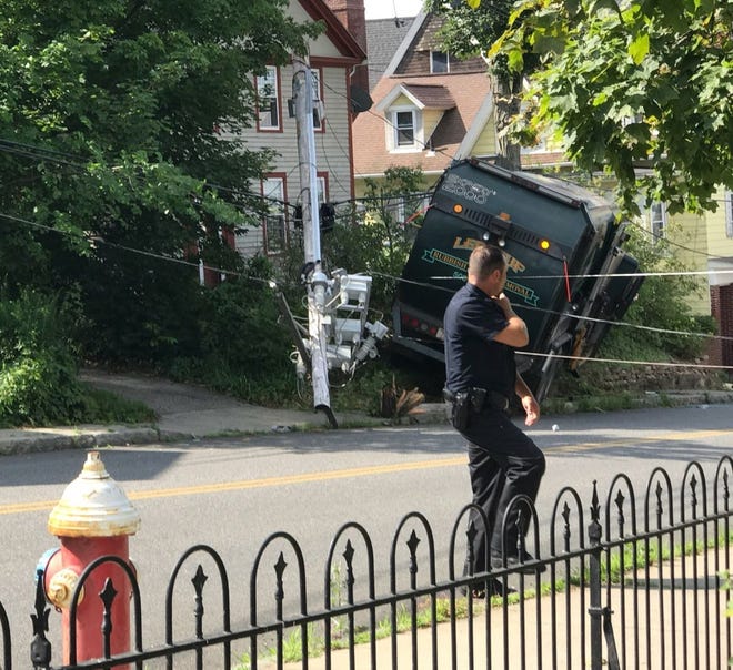 Police investigate after the fatal trash truck accident in Ware. [T&G Staff/Kim Ring]