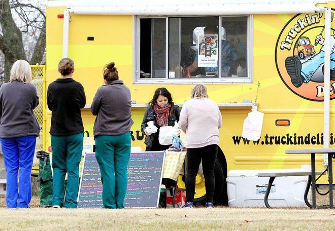 Sarah Smith packages customer orders from Truckin' Delicious on Dec. 6, 2016, in the Sparks Medical Plaza parking lot. [TIMES RECORD FILE PHOTO]