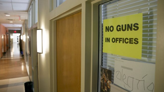 A sign prohibiting guns is posted on a faculty member’s office in the Student Activity Center on the first day of the new campus carry law Monday August 1, 2016. JAY JANNER / AMERICAN-STATESMAN