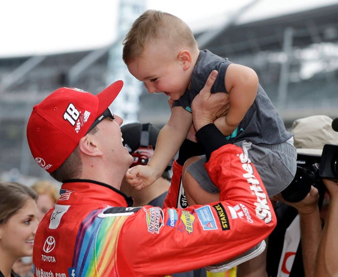 Kyle Busch talks with his son, Brexton, after winning the pole for the NASCAR Cup auto race at Indianapolis Motor Speedway Saturday. (AP Photo/Darron Cummings)