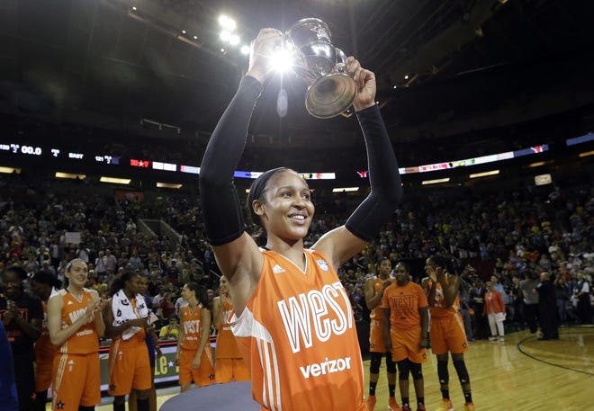 Lynx forward Maya Moore, of the Western Conference, holds up a trophy after being named MVP of the WNBA All-Star game on Saturday. The West beat the East, 130-121. [AP Photo/Elaine Thompson]