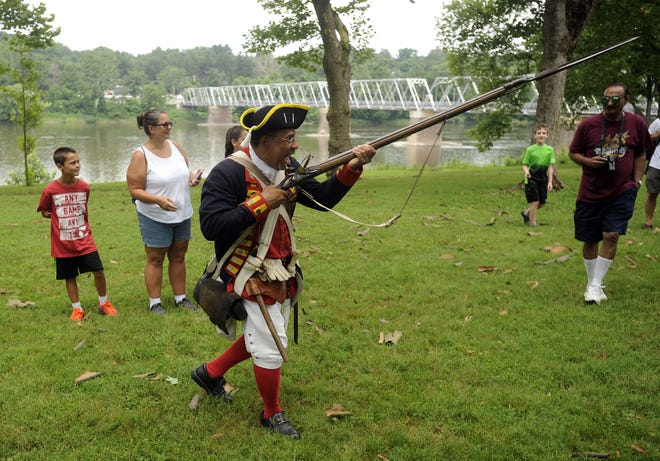 Noah Lewis, of Upper Darby, portraying Ned Hector, 3rd Artillery, demonstrates a charge at Sunday's 100th anniversary of Washington Crossing Historic Park in Upper Makefield on Sunday, July 23, 2017.