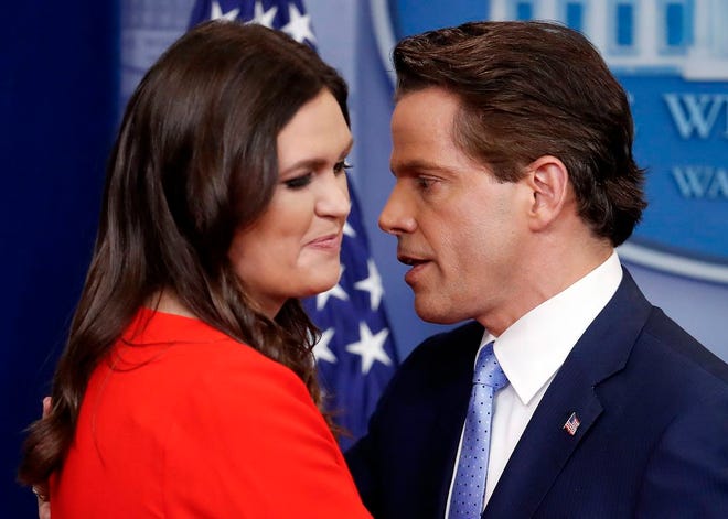 Sarah Huckabee Sanders who has been named White House press secretary and White House communications director Anthony Scaramucci pass at the podium during the press briefing in the Brady Press Briefing room of the White House in Washington, Friday, July 21, 2017. (AP Photo/Pablo Martinez Monsivais)