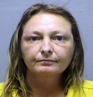This file photo provided by the Genesee County Sheriff’s Department in Flint, Mich., shows Lisa Corcoran, of Vienna Township, who is accused of stealing a handmade bench, flowers and other objects from local cemeteries that were later used to decorate her home. A judge in Flint sentenced Corcoran on Monday, July 24, 2017, to nine months in jail, with credit for 36 days already served. (Genesee County Sheriff’s Department via AP, File)