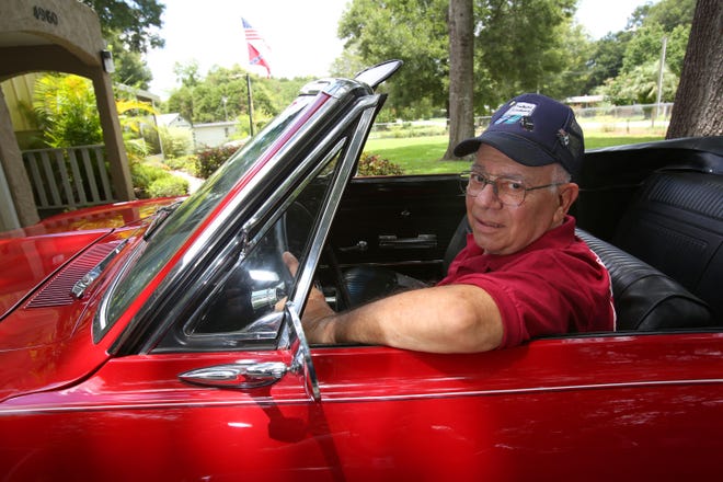 Joe Spatola poses for a photo with his 1965 Corvair Corsa at his home in Summerfield on Thursday. Spatola bought the car two years ago after it was totally restored to its original condition. The classic 4-speed has four carburetors, 140 horsepower and cost $2,600 new, according to Spatola. [Bruce Ackerman/Staff photographer]