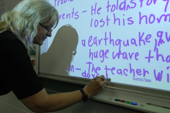 Teacher Betty Sheffield writes on a Smart Board for students during the Third Grade Summer Reading Camp at College Park Elementary School in Ocala on June 21. The School Board is in the process of working out the 2017-18 budget. [Bruce Ackerman/Ocala Star-Banner]