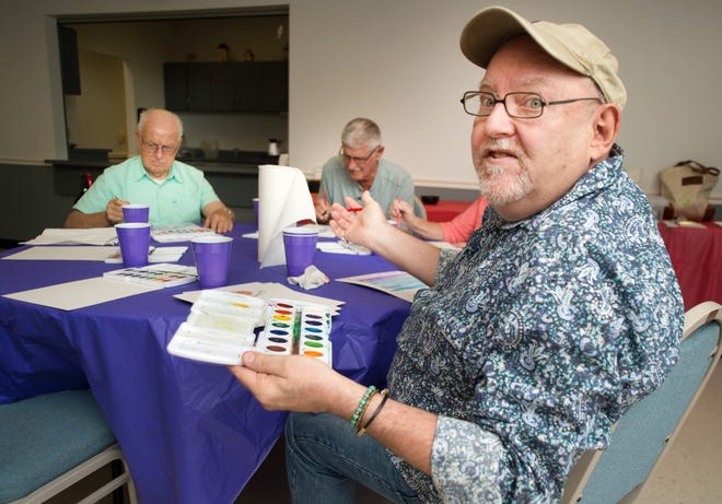 David D'Alessandris leads a Memories in the Making painting class Thursday at Marion Senior Services in Ocala. Materials for the program were provided through a sponsiorship by Edward Jones and Jim Hilty Sr. [Dave Schlenker/Staff photo]