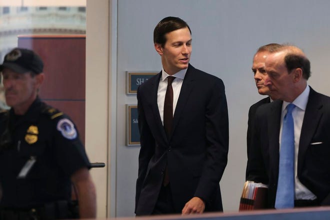 White House senior adviser Jared Kushner, center, accompanied by his attorney Abbe Lowell, right, arrives on Capitol Hill on Monday, to meet behind closed doors before the Senate Intelligence Committee.