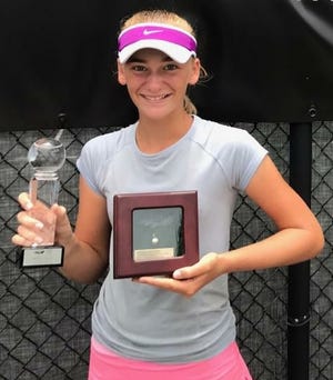 Ava Krug shows off her trophy for winning the USTA Girls 12s doubles title at Delray Beach. [COURTESY PHOTO]