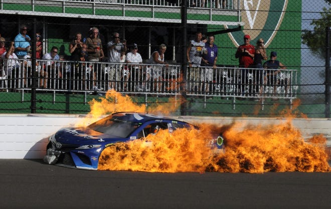 Martin Truex Jr., who had one of the best cars in the Brickyard 400 field, saw his day end in flames following a crash with Kyle Busch. [AP photo]
