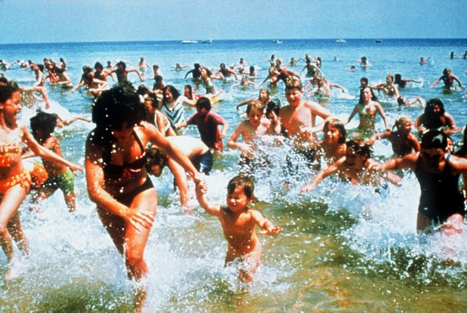 Beach-goers run from the water in a scene from the 1975 classic "Jaws." [AP Photo/Universal Studios]