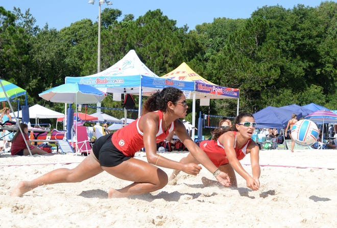 Savannah Pesante, left, and Zeena Khazendar dive after the ball at the American Beach Tour Junior Championship volleyball tournament at Hickory Point Beach Sand Volleyball Complex on Wednesday in Tavares. The tournament will continue through Friday. [AMBER RICCINTO / DAILY COMMERCIAL]