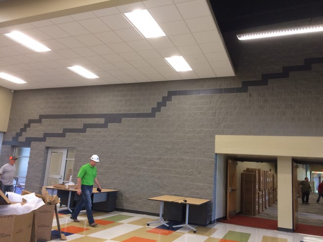 The dark gray line incorporated in the wall at the entrance of the new Fort Larned Elementary School in Larned represents the Santa Fe Trail. Important landmarks on the trail will be painted in later. [Mary Clarkin/HutchNews]