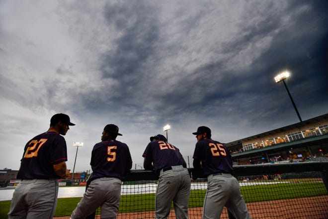 RON JOHNSON/JOURNAL STAR Cedar Rapids Kernels players stand in the dugout and wait during a rain delay in Wednesday's Midwest League game with the Chiefs at Dozer Park. The game was later postponed with a double-header scheduled for Thursday.