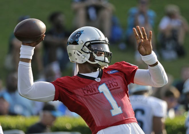 Carolina Panthers quarterback Cam Newton looks to throw a pass during training camp on Wednesday at Wofford College in Spartanburg, S.C. [CHUCK BURTON/THE ASSOCIATED PRESS]