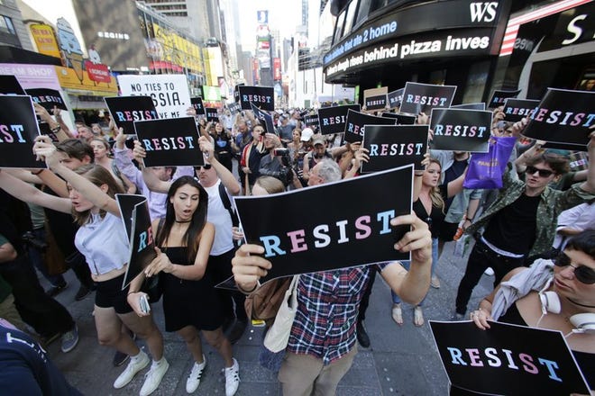 Protesters gather in Times Square, Wednesday, July 26, 2017, in New York. President Donald Trump declared a ban Wednesday on transgender troops serving anywhere in the U.S. military, catching the Pentagon flat-footed and unable to explain what it called Trump’s “guidance.” His proclamation, on Twitter rather than any formal announcement, drew bipartisan denunciations and threw currently serving transgender soldiers into limbo. (AP Photo/Frank Franklin II)