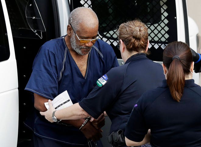 James Mathew Bradley Jr., left, arrives at the federal courthouse for a hearing, Monday, July 24, 2017, in San Antonio. Bradley was arrested in connection with the deaths of multiple people packed into a broiling tractor-trailer. (AP Photo/Eric Gay)