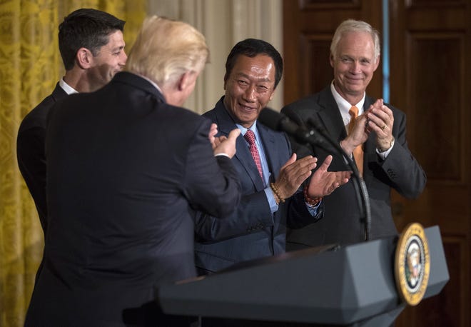 President Donald Trump applauds the announcement Wednesday that Foxconn will build a huge manufacturing plant in Wisconsin as, from left, House Speaker Paul Ryan; Terry Gou, president and chief executive officer of Foxconn; and Sen. Ron Johnson join the celebration in the East Room of the White House. Ryan and Johnson are Republicans from Wisconsin. [Carolyn Kaster/The Associated Press]