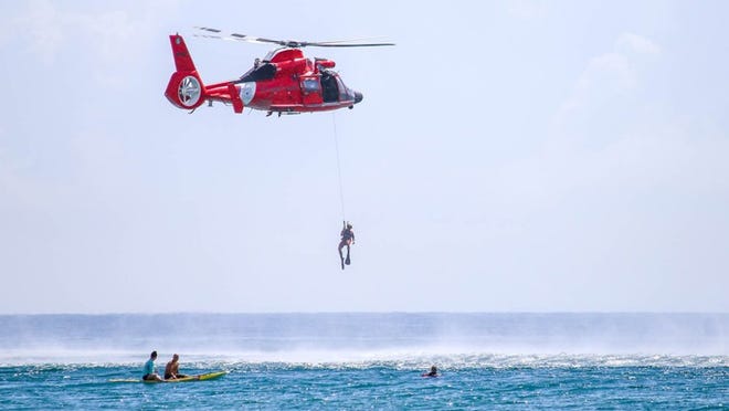 Emergency responders in Palm Beach underwent annual water-rescue training Monday morning with a drill including a Coast Guard helicopter for ocean rescues. (Carla Trivino / Daily News)