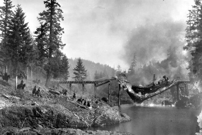 Lane County's most famous train wreck was actually staged, for Buster Keaton's 1926 movie, "The General." This candid photo was snapped between frames of the film. The engine remained in the river for years until it was salvaged for scrap metal. The remnants of the bridge are on private property today. (Courtesy of the Cottage Grove Museum)