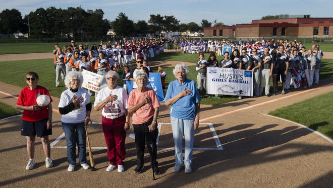 Former All-American Girls Professional Baseball League players Jeneane Lesko (from left), Maybelle Blair, Ange Armato, Joyce Hill Westerman and Shirley Burkovich stand at home plate during the singing of the national anthem Thursday, July 27, 2017, during the opening ceremony for Baseball For All's 2017 Nationals at Beyer Stadium in Rockford. [MAX GERSH/RRSTAR.COM STAFF]