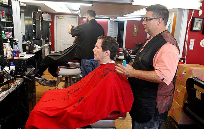 David Rotella owner of Dave and Vinny's Barber Shop in Stoughton cuts Alex Moore of Canton hair on Wednesday, July 26, 2017. Dave and Vinny's has been cutting hair in Stoughton for the last 60 years.