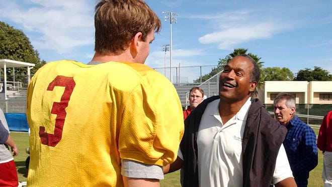 University of Southern California quarterback Carson Palmer talks to O.J. Simpson on Dec. 28, 2002, after practice for the Orange Bowl in Davie, Fla. (Associated Press, file)