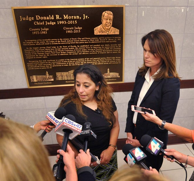 State Attorney Melissa Nelson (right) listens to Darlene Farah speak after a hearing for James Xavier Rhodes, who is charged with murdering Farah’s daughter, Shelby Farah while she was working at the Metro PCS store on north Main Street in 2013. Nelson accepted a guilty plea in exchange for no death penalty during the hearing Thursday, March 2, 2017 at the Duval County Courthouse in Jacksonville, Florida. (Will Dickey/Florida Times-Union)