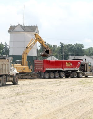 Sparks & Sons Excavating & Trucking removes concrete from the demolished stage at the fairgrounds. [ANDY BARRAND PHOTO]