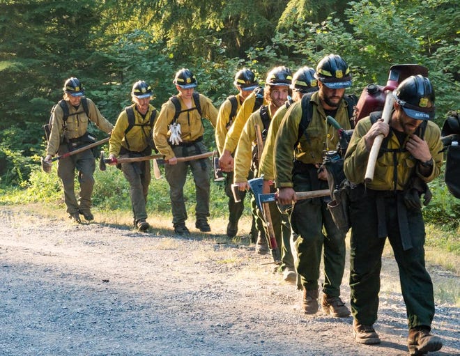 Firefighters march near an 80-acre wildfire in the Mount Jefferson Wilderness near Detroit. The fire prompted closure of hiking trails earlier in the week, but firefighters reported it contained Thursday. (Marcus Kauffman)