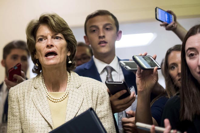 Senator Lisa Murkowski answers questions from journalists while rushing to votes concerning the Republican version of the healthcare bill on Capitol Hill. [Melina Mara, The Washington Post]