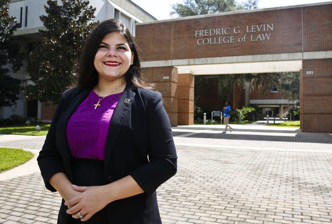 Reino Saco, who was named a 2017 class of Equal Justice Works Fellow from over 450 applications, is shown outside of the Fredric G. Levin College of Law in Gainesville on Friday. Each Fellow designs a unique project to address an unmet legal need. For her project, Saco hopes to help migrant and seasonal farm workers get affordable, safe and sanitary housing. [Andrea Cornejo/Staff photographer]