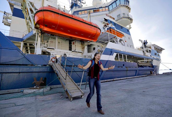 Researcher Daria Gritsenko steps onto land for the first time since setting sail aboard the Finnish icebreaker MSV Nordica as it arrives into Nuuk, Greenland, after traversing the Northwest Passage through the Canadian Arctic Archipelago, Saturday, July 29, 2017. After 24 days at sea and a journey spanning more than 10,000 kilometers (6,214 miles), the MSV Nordica has set a new record for the earliest transit of the fabled Northwest Passage. The once-forbidding route through the Arctic, linking the Pacific and the Atlantic oceans, has been opening up sooner and for a longer period each summer due to climate change. (AP Photo/David Goldman)