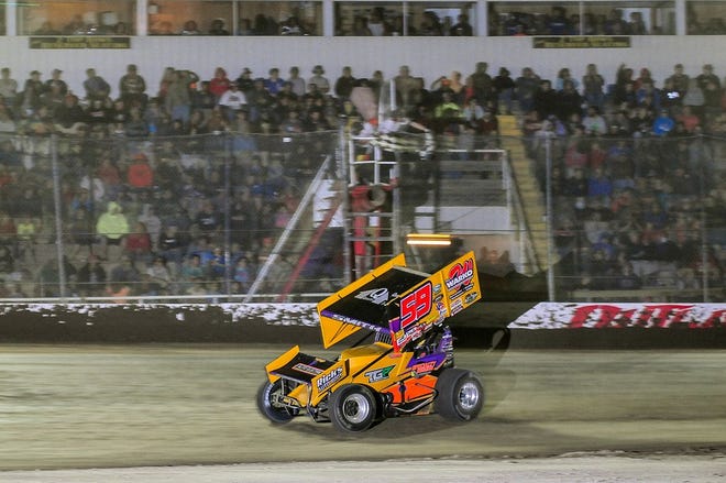 Ryan Smith held off a competitive field to win the sprint car race before a large crowd Friday night in Dundee.