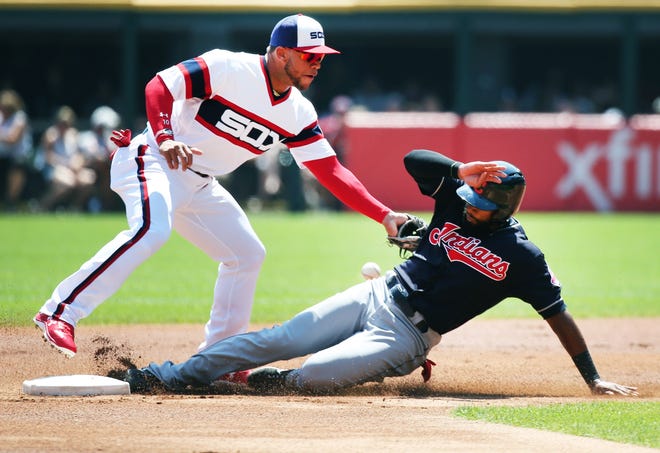 The Indians' Austin Jackson slides in for a steal of second base as White Sox second baseman Yoan Moncada can't come up with the throw in the first inning. [Nuccio DiNuzzo/Chicago Tribune]