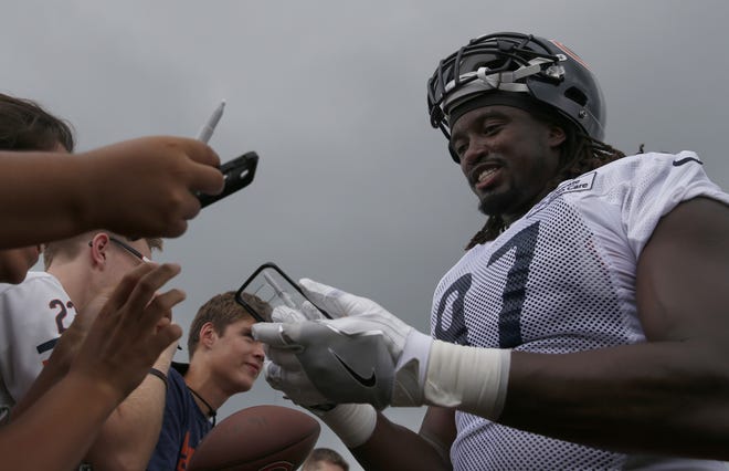 Chicago Bears linebacker Willie Young signs autographs for fans Thursday's training camp session in Bourbonnais. The Bears are coming off a last-place finish in the NFC North at 3-13 and one of their worst seasons in decades, yet they believe they have the makings of a strong front seven if they stay healthy. [AP Photo/Nam Y. Huh]