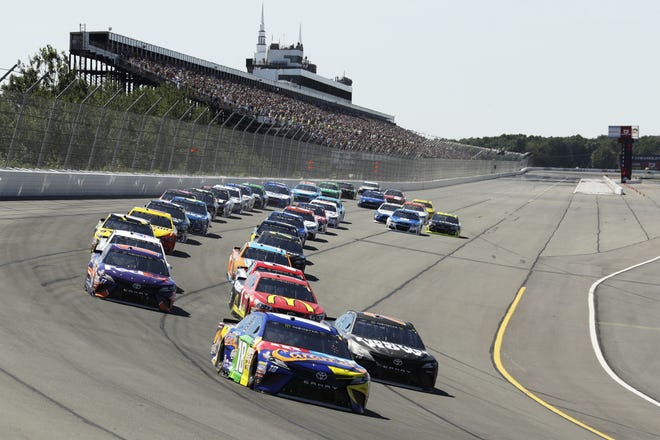 Kyle Busch leads the field on Sunday into Turn 1 at Pocono Raceway. Busch won the race, putting himself in position to make NASCAR's playoffs at the end of the season. [AP Photo/Matt Slocum]