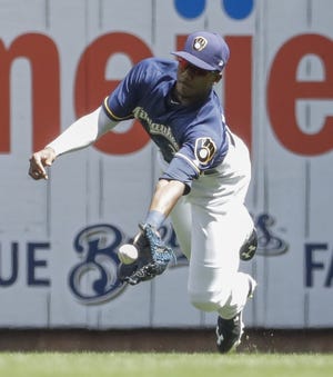 Milwaukee Brewers center fielder Lewis Brinson makes a diving catch on a ball hit by Chicago Cubs' Addison Russell during the fourth inning Sunday, July 30, 2017, in Milwaukee. [MORRY GASH/THE ASSOCIATED PRESS]