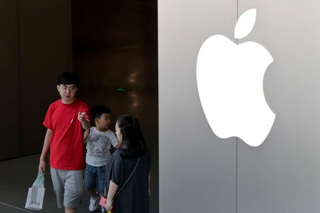 A Chinese family walks out of an Apple store in Beijing Sunday. China appears to have succeeded in eliminating software programs that enable its people to view an uncensored internet. Companies that let people avoid the government filters said Saturday their programs have been removed from Apple's app store in China.