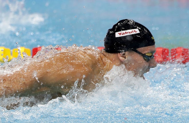 United States' Caeleb Dressel swims toward the gold medal in the men's 100-meter butterfly Saturday at the World Aquatics Championships in Budapest, Hungary. [Petr David Josek/Associated Press]
