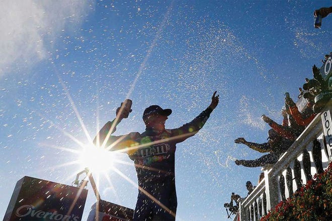 Kyle Busch celebrates in Victory Lane after winning the Overton's 400 at Pocono Raceway on Sunday in Long Pond, Pa.