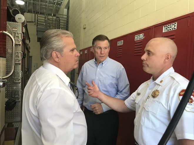State Republican Rep. John Torbett, R-Gaston, (from left) state Fire Marshal Mike Causey and Mount Holly Fire Chief Ryan Baker talk during a tour of the Mount Holly Fire Department on Monday. [Photo by Adam Lawson/The Gaston Gazette]