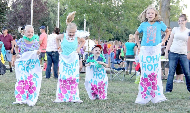Children take part in a sack race during Kids Day in the Park Friday night in Quincy. [Karri Gruner Photo]